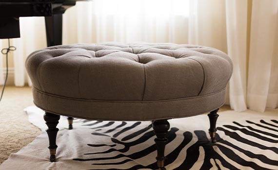 Tufted ottoman in living room